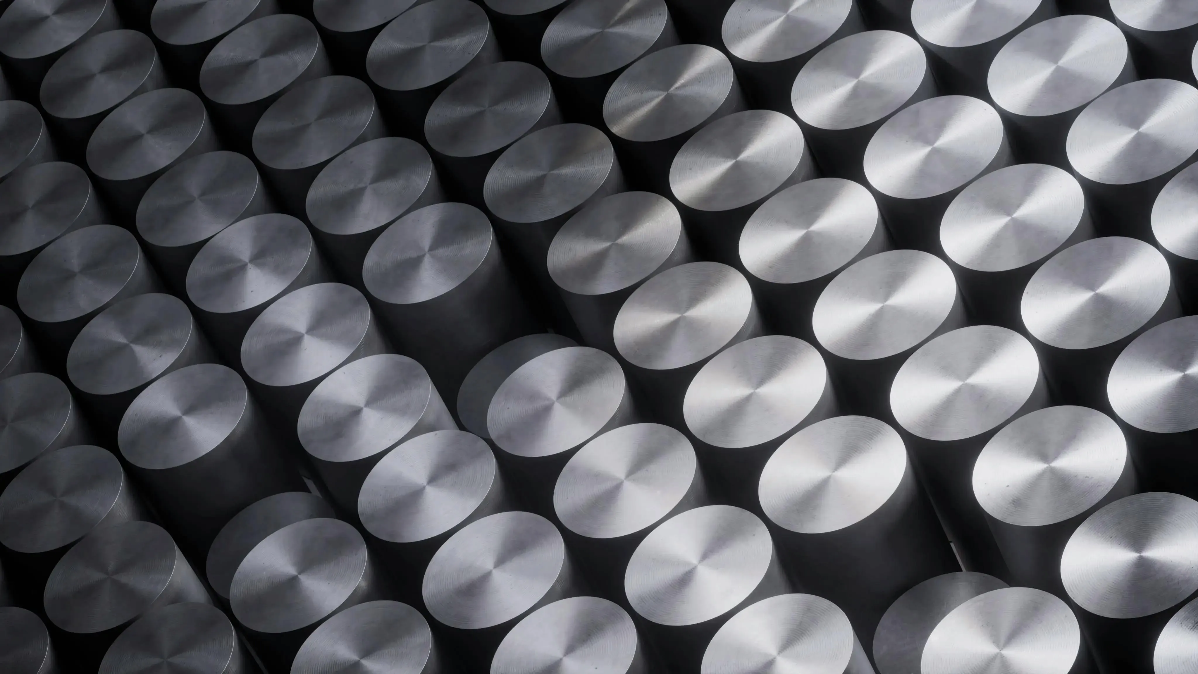 An arrangement of nuclear fuel pellets, which are shiny and cylindrical.