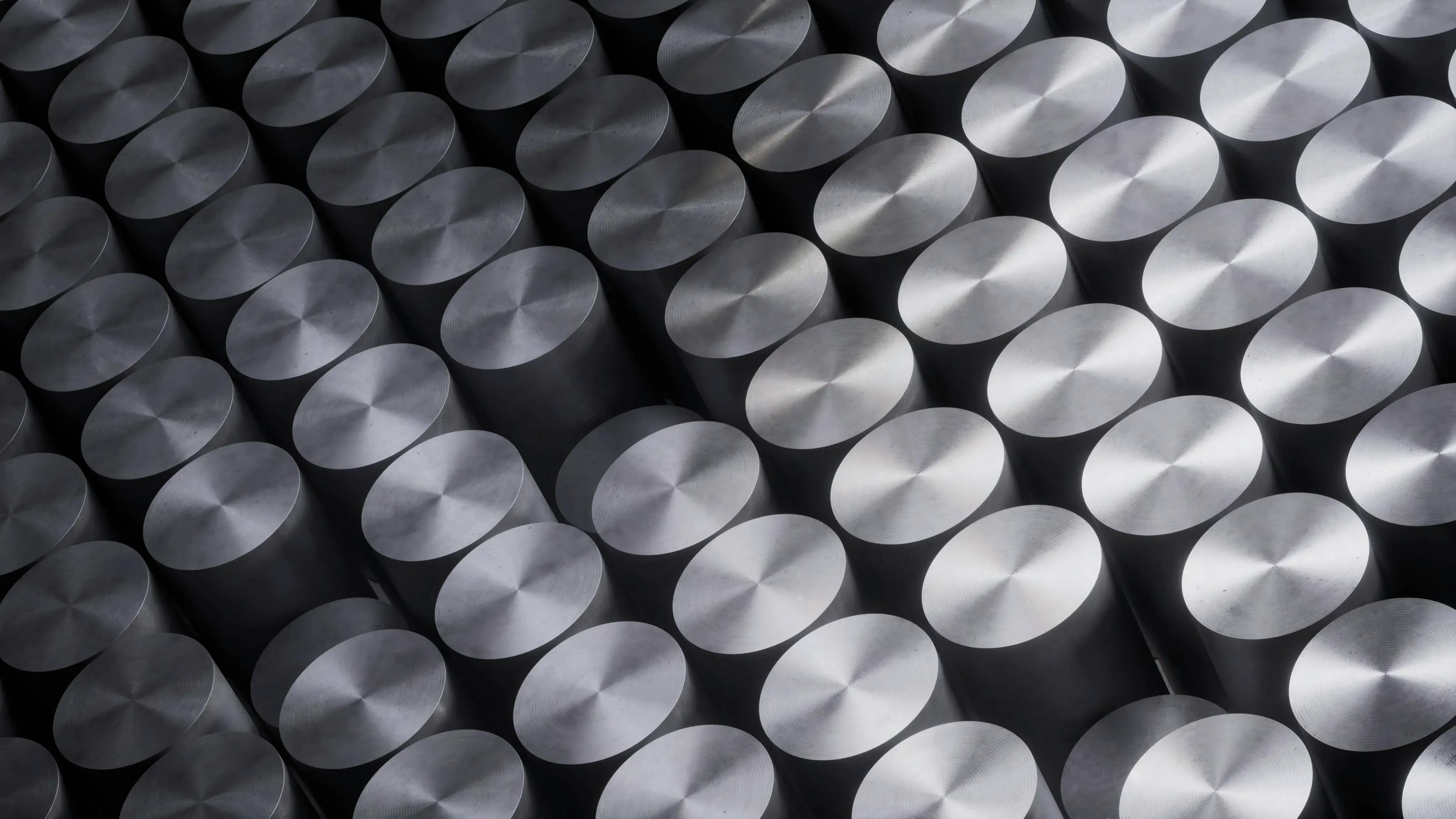 An arrangement of nuclear fuel pellets, which are shiny and cylindrical.