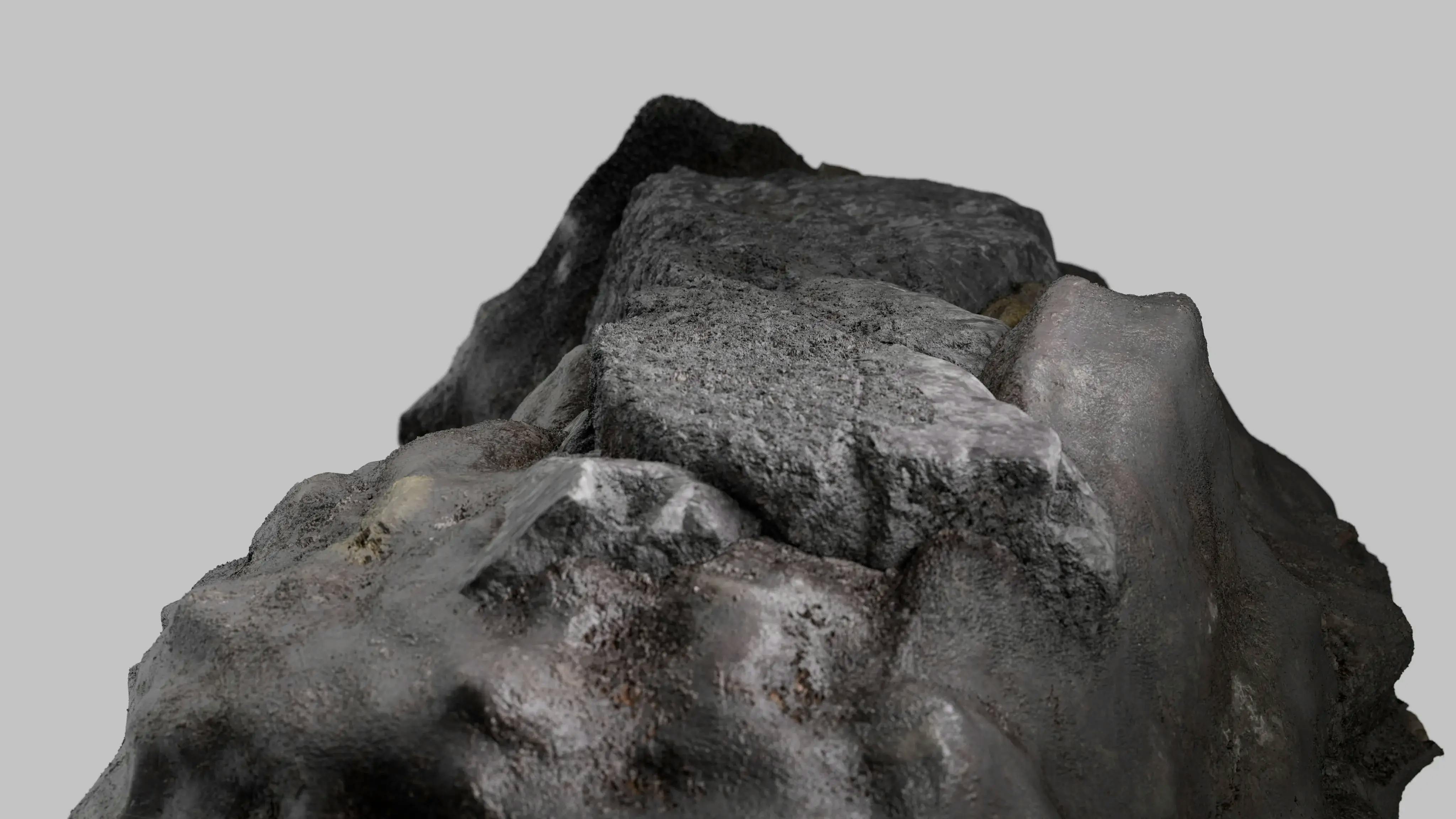 A piece of uraninite (a major uranium ore mineral) floating on a grey background. 